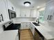 Bright updated kitchen featuring white cabinets and stainless steel appliances at 20016 Walter Henderson Rd, Cornelius, NC 28031