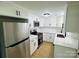 Modern kitchen with stainless steel refrigerator, white cabinetry, and sleek countertops at 20016 Walter Henderson Rd, Cornelius, NC 28031