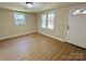 Bright living room with laminate floors, fresh paint, multiple windows, and ample natural light, creating a move-in-ready space at 20016 Walter Henderson Rd, Cornelius, NC 28031