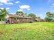 Exterior view of a ranch style home with an expansive backyard and mature trees at 202 College Ave, Shelby, NC 28152