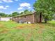 Spacious backyard of a brick home with mature trees and a storage shed at 202 College Ave, Shelby, NC 28152