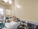 Bright bathroom featuring a vanity, mirror, and neutral-colored fixtures, with a window for natural light at 202 College Ave, Shelby, NC 28152
