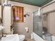 Bathroom with a shower-tub combination, a vintage window, and tiled walls at 202 College Ave, Shelby, NC 28152