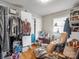 Bedroom featuring storage, a disorganized closet, a lounge chair, and a window offering natural light at 202 College Ave, Shelby, NC 28152