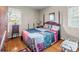 Cozy bedroom with hardwood floors, a large bed, and a bright window providing natural light at 202 College Ave, Shelby, NC 28152