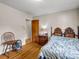 Bedroom featuring a carved-wood bed frame, nightstand with lamp, and a window for natural light and ventilation at 202 College Ave, Shelby, NC 28152