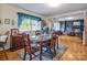 Comfortable dining area with natural lighting, wood floors, and access to the cozy living room at 202 College Ave, Shelby, NC 28152