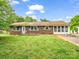 Charming brick home with green shutters, a porch, and a well-manicured front lawn at 202 College Ave, Shelby, NC 28152