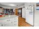 Functional kitchen area with bright white appliances and view to the dining area at 202 College Ave, Shelby, NC 28152