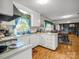 Bright kitchen featuring white cabinetry, laminate countertops, and an open layout at 202 College Ave, Shelby, NC 28152