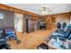 Comfortable living room showcasing wood accent walls, hardwood flooring, and comfortable seating at 202 College Ave, Shelby, NC 28152