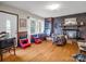 Cozy living room featuring a brick fireplace, hardwood floors, and natural light from the windows at 202 College Ave, Shelby, NC 28152