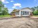 Sunroom with lots of windows, an AC unit, and wheelchair ramp to the back door at 202 College Ave, Shelby, NC 28152