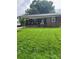 Charming brick ranch home with a well-maintained lawn, inviting front porch, and beautiful landscaping at 202 Kenwood Ave, Cherryville, NC 28021