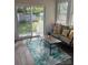 Bright sunroom featuring a comfortable sofa, large windows, and an inviting view of the backyard at 202 Kenwood Ave, Cherryville, NC 28021