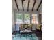 Cozy sunroom featuring natural light, exposed wood beams, shiplap walls and charming decor at 202 Kenwood Ave, Cherryville, NC 28021