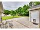 Spacious backyard with a patio, lush trees, and a shed at 2023 E Park Dr, Lancaster, SC 29720