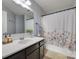 Bathroom featuring a single vanity, bathtub with floral shower curtain, and neutral-colored walls at 2023 E Park Dr, Lancaster, SC 29720
