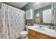 Bathroom with wood vanity, floral shower curtain, and neutral-colored walls at 2023 E Park Dr, Lancaster, SC 29720