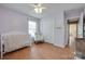 Bright bedroom with wood floors, light purple walls, crib, rocking chair, and a closet at 2023 E Park Dr, Lancaster, SC 29720