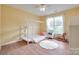 Cozy bedroom with wood floors, yellow walls, rug, play structure, and a window at 2023 E Park Dr, Lancaster, SC 29720