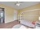 Cozy bedroom with wood floors, yellow walls, rug, play structure, and a window at 2023 E Park Dr, Lancaster, SC 29720
