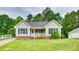 Charming single-story home with a well-maintained front yard and a cozy front porch at 2023 E Park Dr, Lancaster, SC 29720