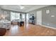 Inviting living room with hardwood floors, neutral paint, and tray ceiling at 2023 E Park Dr, Lancaster, SC 29720
