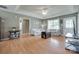 Comfortable living room featuring wood floors, floral sofas and lots of natural light at 2023 E Park Dr, Lancaster, SC 29720