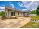Wide shot of the backyard patio with green grass and some trees on a sunny day at 2027 Ellison Dr, Rock Hill, SC 29730