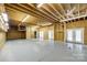 Large unfinished basement space with exposed beams, lighting, a doorway, and double doors at 2027 Ellison Dr, Rock Hill, SC 29730