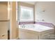 Close up of a soaking tub with jets and tile surround at 2027 Ellison Dr, Rock Hill, SC 29730