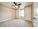 A bright bedroom features neutral colored carpet and paint, a ceiling fan, and a window at 2027 Ellison Dr, Rock Hill, SC 29730