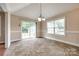 Dining area featuring neutral walls, tile floors, and sliding glass doors to the backyard at 2027 Ellison Dr, Rock Hill, SC 29730