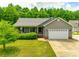 Charming single-story home with a manicured lawn, two-car garage, and inviting front porch at 2027 Ellison Dr, Rock Hill, SC 29730