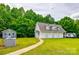 Exterior side view of home with ample lawn space and wooded area in background at 2027 Ellison Dr, Rock Hill, SC 29730