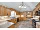 Well-lit kitchen featuring light wood cabinetry, granite counters, tiled backsplash and modern appliances at 2027 Ellison Dr, Rock Hill, SC 29730