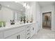Elegant bathroom with double vanity, stylish fixtures, and a walk-in closet with hanging storage at 2045 Mantle Ridge Dr, Indian Trail, NC 28079