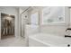 Bright bathroom features a soaking tub, shower, and walk-in closet for all your storage needs at 2045 Mantle Ridge Dr, Indian Trail, NC 28079