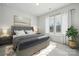 Inviting bedroom with a large window, a comfy bed, and a decorative plant for a serene atmosphere at 2045 Mantle Ridge Dr, Indian Trail, NC 28079