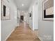 Inviting hallway with hardwood floors and modern artwork on the walls at 2045 Mantle Ridge Dr, Indian Trail, NC 28079