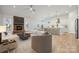 Open-concept living room featuring a stone fireplace and view into kitchen at 2045 Mantle Ridge Dr, Indian Trail, NC 28079