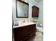 Cozy bathroom with a wooden vanity cabinet and matching mirror at 202 Kenwood Ave, Cherryville, NC 28021