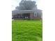 Charming brick home featuring a covered front porch, complemented by a lush green lawn at 202 Kenwood Ave, Cherryville, NC 28021