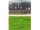Cozy front porch featuring a swing and flower bed, perfect for relaxing outdoors at 202 Kenwood Ave, Cherryville, NC 28021