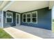 Covered back porch of home features large windows and lots of light at 256 W Waterlynn Rd, Mooresville, NC 28117