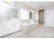 Bright bathroom with a modern tub, shower, and double sink at 256 W Waterlynn Rd, Mooresville, NC 28117