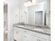 Bright bathroom with a double sink, granite countertop, and white cabinets at 256 W Waterlynn Rd, Mooresville, NC 28117