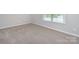 Carpeted room with natural light streaming through the window at 256 W Waterlynn Rd, Mooresville, NC 28117