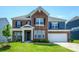 Beautiful two-story brick home featuring classic architecture, a manicured lawn, and attached garage at 256 W Waterlynn Rd, Mooresville, NC 28117